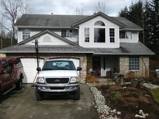 Before: a rotten asphalt shingle roof on the home, Mission, British Columbia, ahead of a Charcoal Grey Interlock Slate aluminum roof