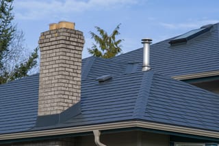 Deep Charcoal Interlock Slate aluminum roof on a deep charcoal metal roof on a single-family home in rural, Surrey, British Columbia