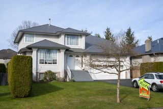 Musket Grey Interlock Slate aluminum roof on a two-storey home with a grey metal roof in a suburban, Surrey, British Columbia