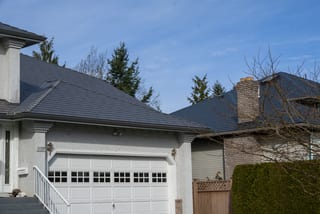 Musket Grey Interlock Slate aluminum roof on a Musket Grey metal roof on a two-storey house in a rural, Surrey, British Columbia