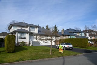 Musket Grey Interlock Slate aluminum roof on a two-storey home with a grey metal roof in a suburban, Surrey, British Columbia