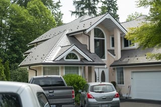 Weathered Interlock Slate aluminum roof on a modern home with a metal roof in a forested suburban area, Port Coquitlam, British Columbia
