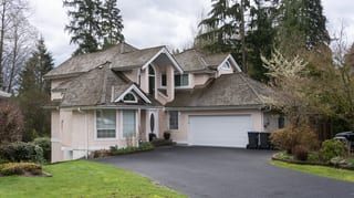 Before: a leaking wood shake roof on the home, Port Coquitlam, British Columbia, ahead of a Weathered Interlock Slate aluminum roof