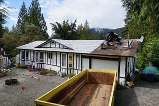 Deep Charcoal Interlock Slate aluminum roof being installed on the home, replacing a mossy asphalt shingle roof, Mission, British Columbia