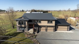 Deep Charcoal Interlock Slate aluminum roof on a two-storey home with a metal roof in a rural setting, Abbotsford, British Columbia