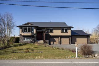 Deep Charcoal Interlock Slate aluminum roof on a brown two-storey home with a metal roof in rural, Abbotsford, British Columbia
