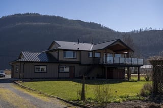 Deep Charcoal Interlock Slate aluminum roof on a two-storey home with a metal roof in a mountain setting, Abbotsford, British Columbia