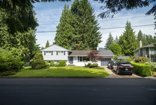 Tudor Brown Interlock Slate aluminum roof on a two-storey Tudor home with dormers and a dark metal roof, North Vancouver, British Columbia