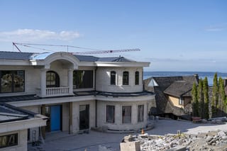 Deep Charcoal Interlock Slate aluminum roof being installed on the home, replacing new construction, West Vancouver, British Columbia