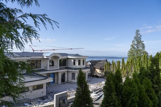 Deep Charcoal Interlock Slate aluminum roof being installed on the home, replacing new construction, West Vancouver, British Columbia