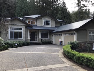 Two-story Craftsman home in North Vancouver with Interlock deep charcoal aluminum slate metal roofing featuring a multi-plane complex roof and covered front entry.