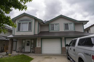 Tudor Brown Interlock Cedar Shingle aluminum roof on a Tudor style home with dormers in a rural suburban area, Maple Ridge, British Columbia