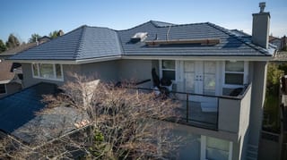 Deep Charcoal Interlock Slate aluminum roof on a two-storey home with a metal roof in Richmond, BC, Richmond, British Columbia