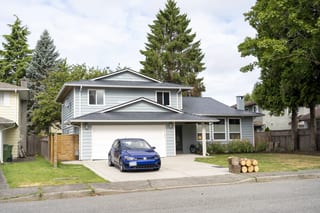 Deep Charcoal Interlock Slate aluminum roof on a two-storey home with a metal roof in a suburban forest, Richmond, British Columbia