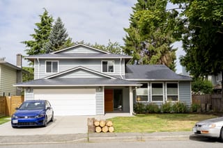 Deep Charcoal Interlock Slate aluminum roof on a two-storey home with a garage and dormers in an urban, Richmond, British Columbia