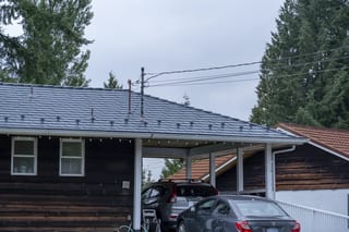 Deep Charcoal Interlock Slate aluminum roof on a house with a metal roof under construction in a forested, North Vancouver, British Columbia
