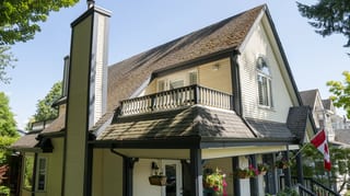Before: a mossy asphalt shingle roof on the home, Vancouver, British Columbia, ahead of a Deep Charcoal Interlock Slate aluminum roof