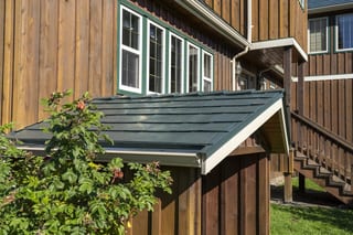 Hunter Green Interlock Slate aluminum roof on a modern single-family home with a green metal roof in a, Langley, British Columbia