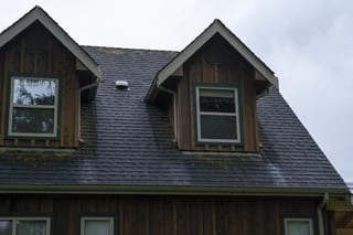 Before: a mossy asphalt shingle roof on the home, Langley, British Columbia, ahead of a Hunter Green Interlock Slate aluminum roof