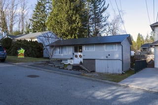 Deep Charcoal Interlock Slate aluminum roof on a Deep Charcoal metal roof on a white ranch style home in a, Mission, British Columbia