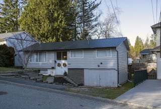 Deep Charcoal Interlock Slate aluminum roof on a grey one-storey home with dormers in a suburban setting, Mission, British Columbia