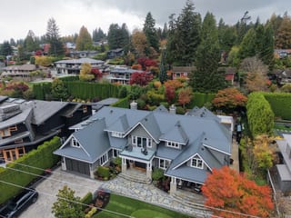 Deep Charcoal Interlock Slate aluminum roof on a Deep Charcoal metal roof on a two-storey home among tall, North Vancouver, British Columbia