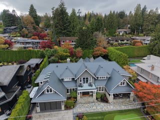 Deep Charcoal Interlock Slate aluminum roof on a grey two-storey home with dormers and a stone walkway in, North Vancouver, British Columbia
