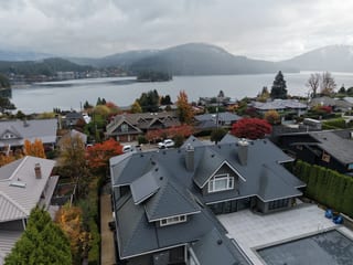 Deep Charcoal Interlock Slate aluminum roof on a dark home with dormers on a waterfront lot, North Vancouver, British Columbia