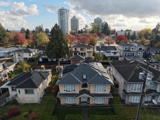 Deep Charcoal Interlock Slate aluminum roof on a two-storey home with dormers in a residential, Burnaby, British Columbia