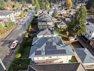 Deep Charcoal Interlock Slate aluminum roof on a beige single-storey home with a metal roof in a forested, Burnaby, British Columbia