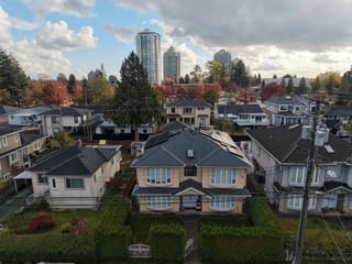 Deep Charcoal Interlock Slate aluminum roof on a two-storey colonial home among trees in an urban/suburban, Burnaby, British Columbia