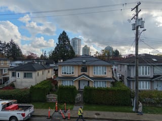 Deep Charcoal Interlock Slate aluminum roof being installed on the home, replacing an asphalt shingle roof being torn off, Burnaby, British Columbia