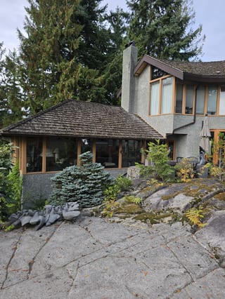 Left elevation of a West Vancouver, BC home showing the original cedar shake roof before its Interlock aluminum Tudor Brown slate replacement.