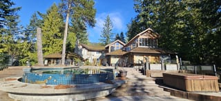Wide-angle view of a West Vancouver, BC home's original 30-year-old cedar shake roof before Interlock aluminum Tudor Brown slate replacement.