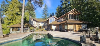 Wide-angle, level view of the aging cedar shake roof on a West Vancouver, BC home prior to its Interlock metal roof replacement.