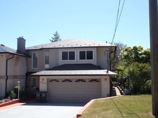 Black Interlock Slate aluminum roof on a two-storey home with a black metal roof in Victoria, BC, Victoria, British Columbia