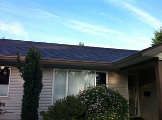 Colonial Brown Interlock Slate aluminum roof on a tan single-family home with a Colonial roof in a rural, Campbell River, British Columbia