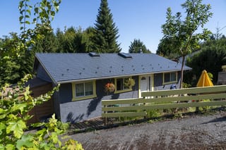 Deep Charcoal Interlock Slate aluminum roof on a Deep Charcoal metal roof on a ranch-style house among, Ladysmith, British Columbia
