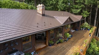 Colonial Brown Interlock Cedar Shingle aluminum roof on a colonial brown roof on a single-family home among tall, Salt Spring Island, British Columbia
