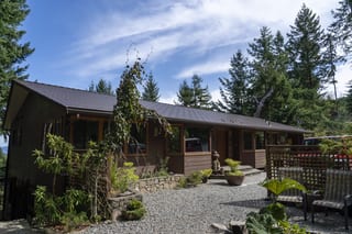 Colonial Brown Interlock Cedar Shingle aluminum roof on a colonial home with a brown roof among trees on Salt, Salt Spring Island, British Columbia