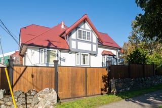 Tile Red Interlock Slate aluminum roof on a white Tudor home with dormers in an urban neighbourhood, Victoria, British Columbia