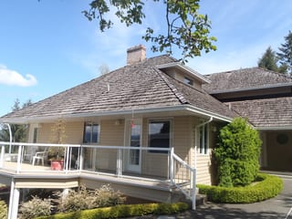 Before: a rotten wood shake roof on the home, Duncan, British Columbia, ahead of a Deep Charcoal Interlock Slate aluminum roof