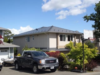Deep Charcoal Interlock Slate aluminum roof on a single-storey modern home in suburban Victoria, Victoria, British Columbia