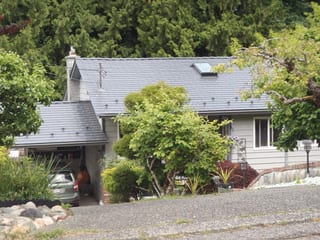 Deep Charcoal Interlock Cedar Shingle aluminum roof on a Deep Charcoal metal roof on a cottage in a forested rural, Ladysmith, British Columbia