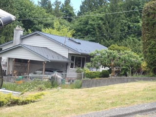 Deep Charcoal Interlock Cedar Shingle aluminum roof on a Deep Charcoal metal roof on a modern home in a forested, Ladysmith, British Columbia