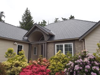 Deep Charcoal Interlock Slate aluminum roof on a modern single-family home with a metal roof among tall, Qualicum Beach, British Columbia