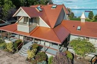 Copper Penny Interlock Slate aluminum roof on a grey modern home with copper metal roof and porch near, Ladysmith, British Columbia