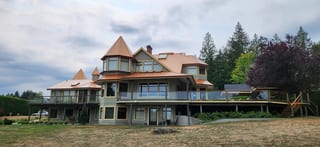Copper Penny Interlock Slate aluminum roof on a large house with copper metal roof in a forested rural, Ladysmith, British Columbia
