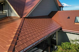 Copper Penny Interlock Slate aluminum roof on a single-family modern home with copper penny metal roof in, Ladysmith, British Columbia