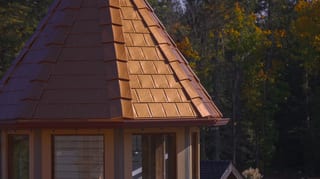 Copper Penny Interlock Slate aluminum roof on a brown roofed home with a copper penny metal roof in a, Ladysmith, British Columbia